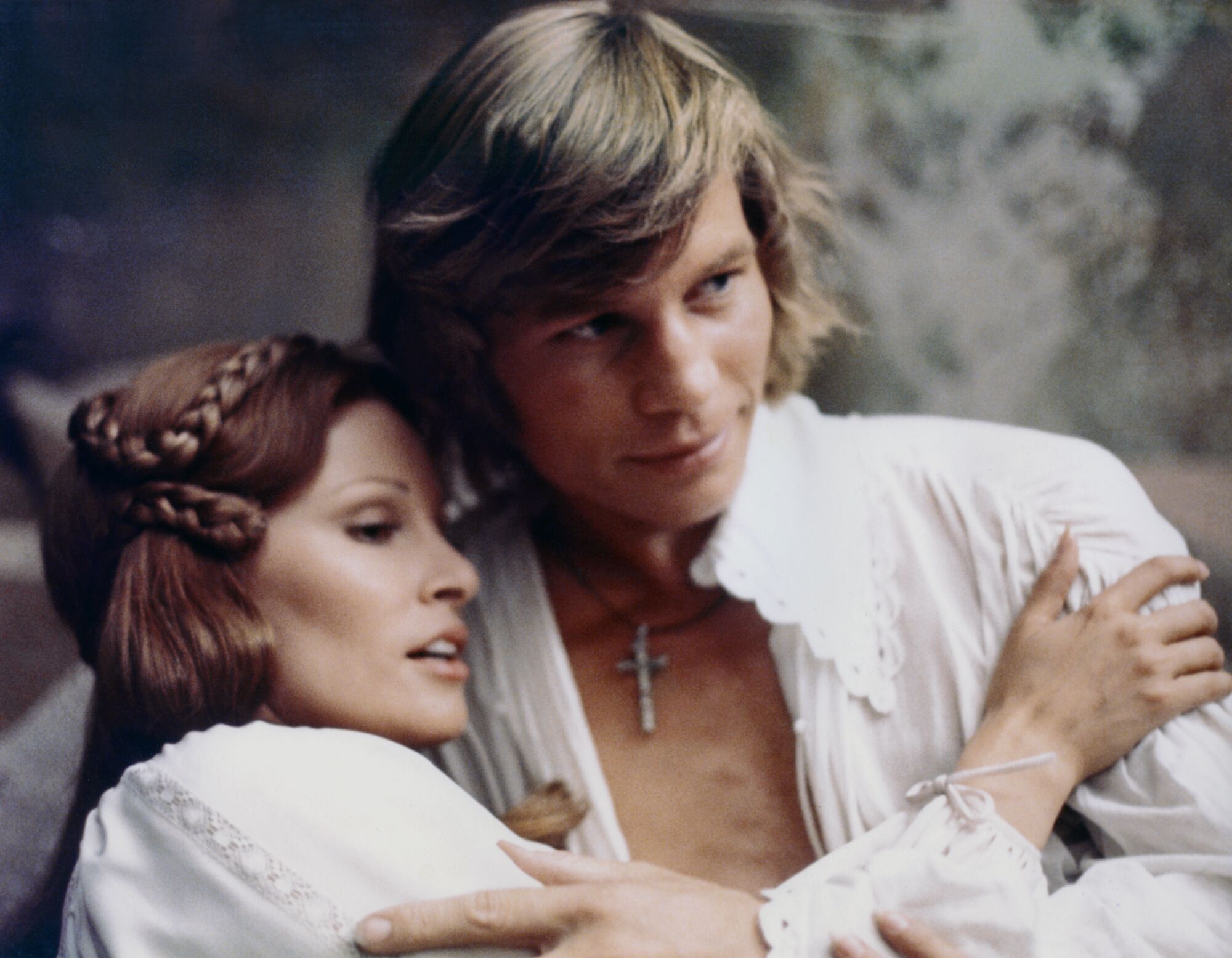 Raquel Welch and British actor Michael York embrace while filming The Three Musketeers.