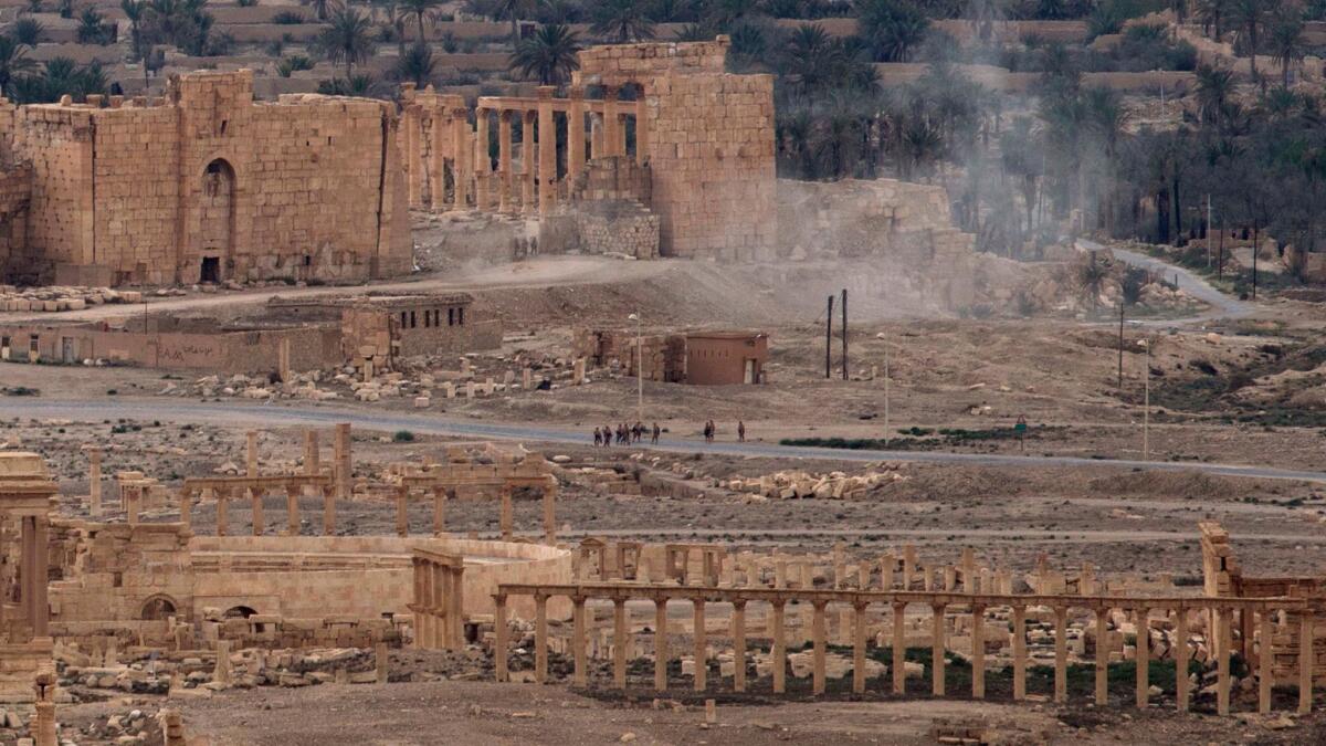 Russian soldiers stand on a road in the ancient city of Palmyra in spring.