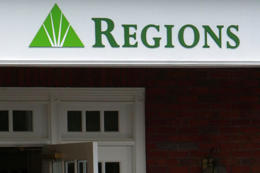 FILE - The logo for Regions Bank is seen above a branch's entrance in Roswell, Ga., Thursday, May 7, 2009. For a second time this decade, Regions Bank was found charging illegal overdraft fees, the government said Wednesday, Sept. 28, 2022, in a settlement that will require the bank to repay $141 million to customers and pay an additional $50 million in fees. (AP Photo/John Bazemore, File)