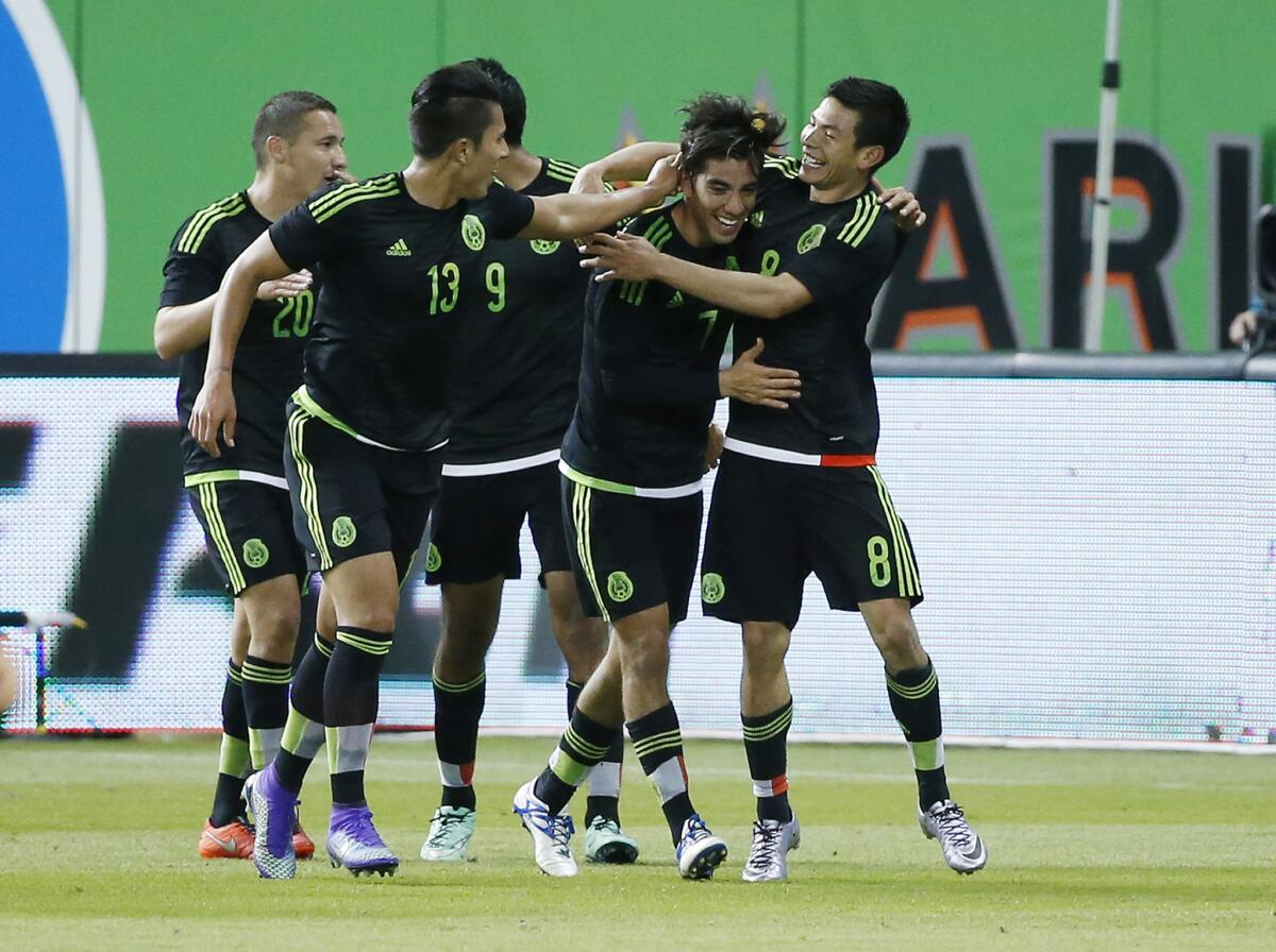 Mexico's Rodolfo Pizarro, second from right, is congratulated by teammates after scoring against Senegal on Feb. 10 in Miami.