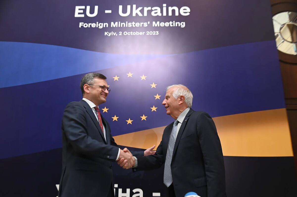 Ukraine's foreign minister shakes hands with EU's top diplomat