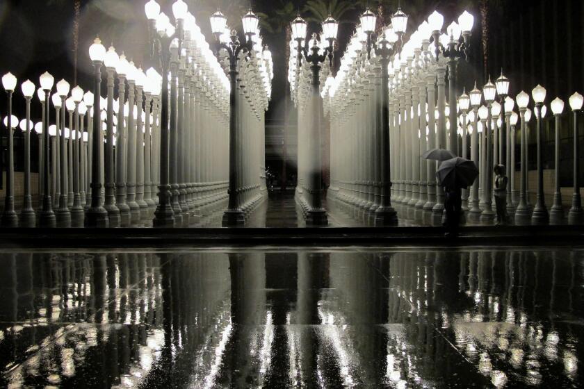 Iconoclastic Los Angeles artist Chris Burden has passed away. His sculpture, "Urban Light," seen here on a rainy night at the L.A. County Museum of Art in 2010, has become a symbol of the city.