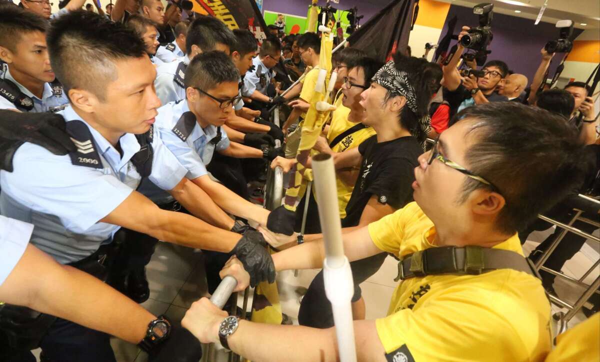 Protesters detain a man they say is a Chinese undercover agent during a demonstration at the Hong Kong airport on Aug. 13, 2019.
