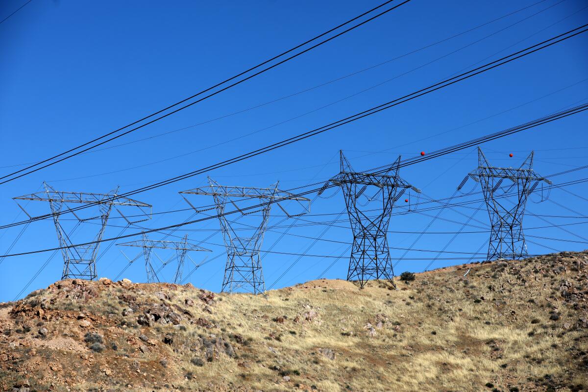 Electric transmission lines against a blue sky.