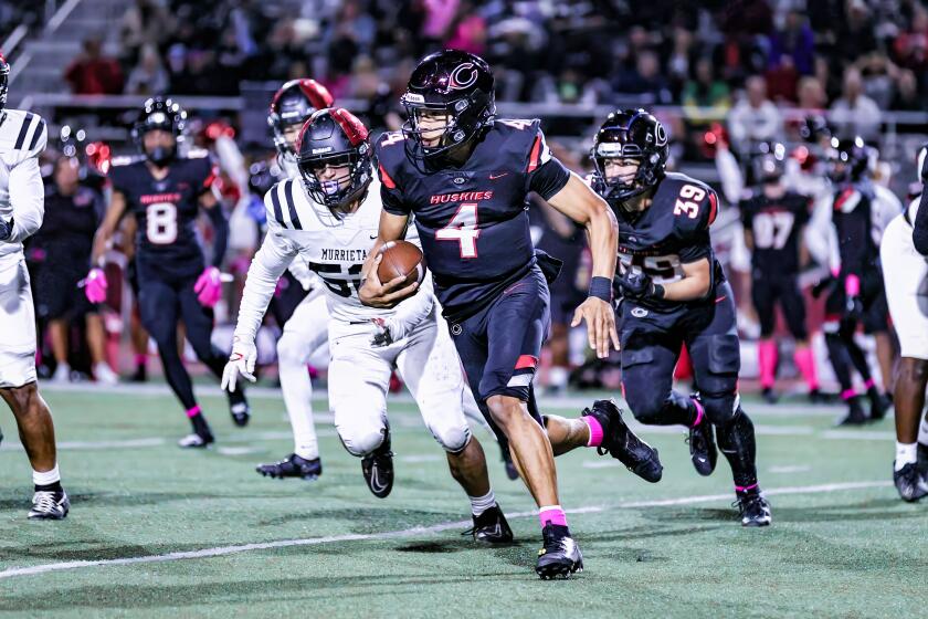 Quarterback Husan Longstreet of Corona Centennial takes off on a run against Murrieta Valley.