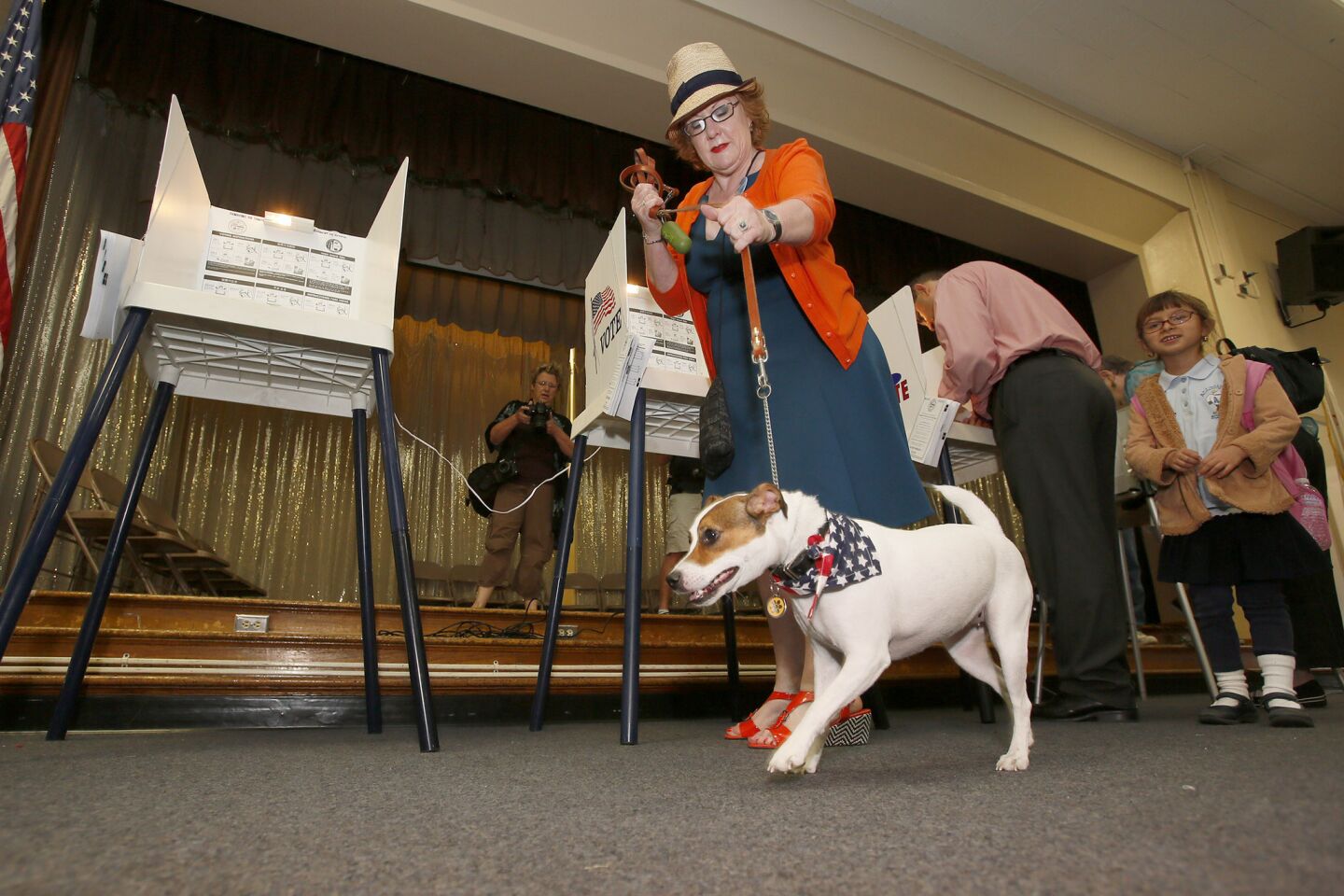 Deborah Murphy tries to control her dog Fiona while voting at Allesandro Elementary School.