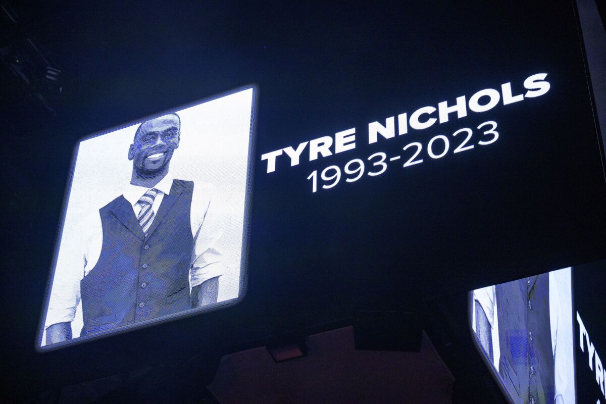 A large video screens shows an image of Tyre Nichols with his name and the years 1993-2023