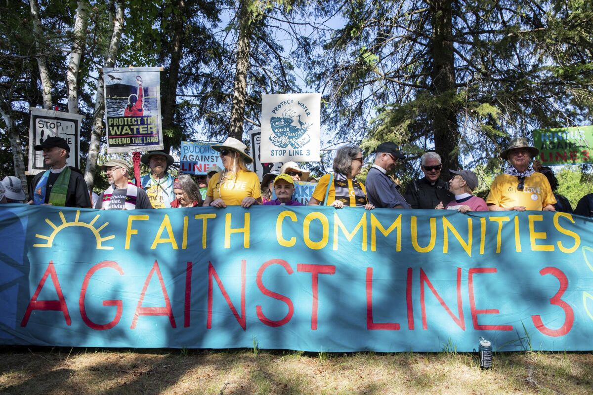 Faith leaders gather for an interfaith prayer gathering before a day of protest action against the Enbridge Line 3 oil pipeline at LaSalle Lake State Recreation Area on Monday, June 7, 2021. (Evan Frost/Minnesota Public Radio via AP)