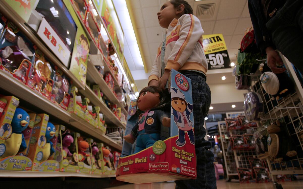 A child checks out toys at KB Toys tore in the West Covina Fashion Plaza.