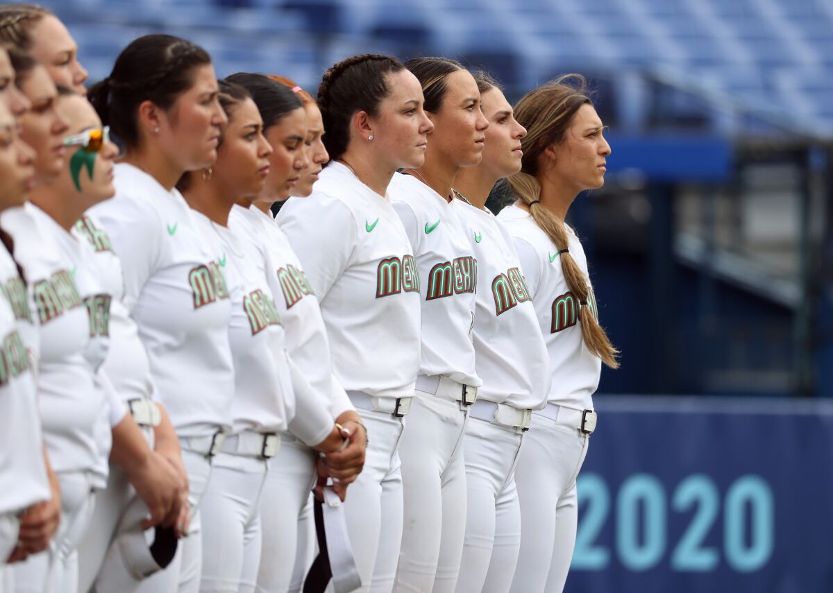 Mexico's softball team lines up on the field at the Tokyo Olympics.