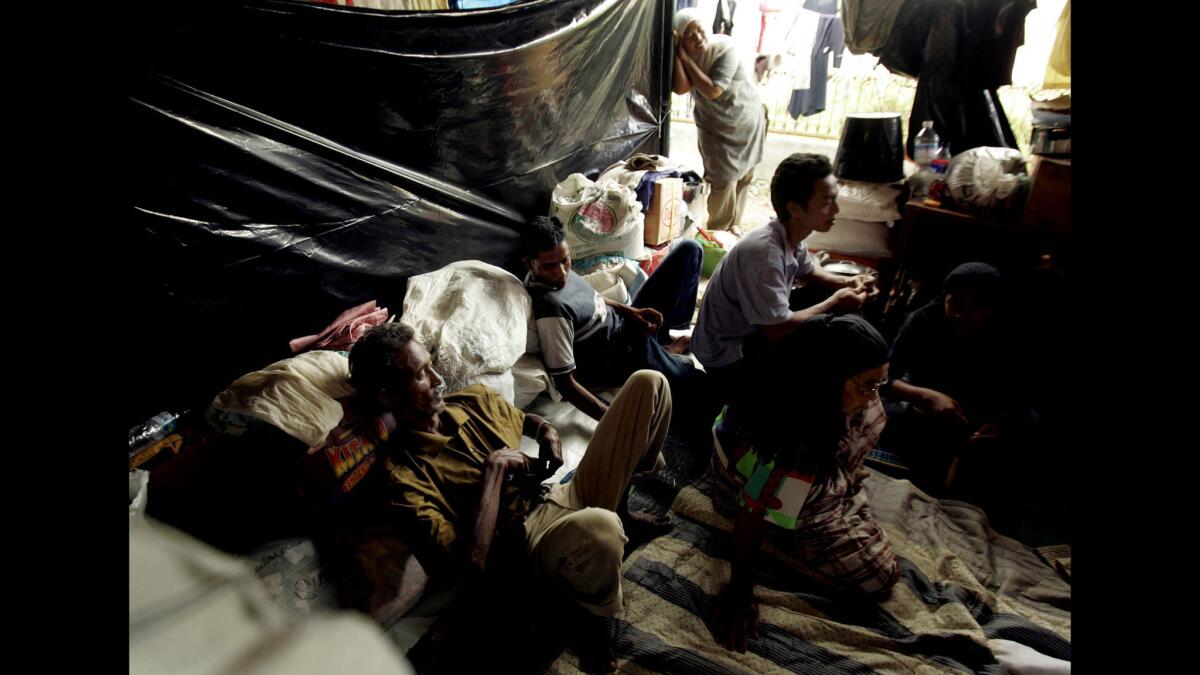 On Jan. 16, 2005, Sofyan Amzit and his family rest in a tent in the Samahani Refugee Camp.