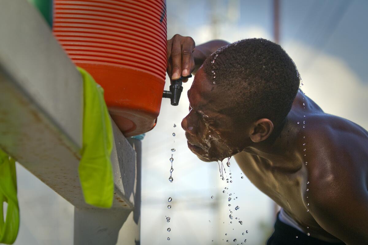 West Los Angeles College cross-country runner Tawuan Cargill dumps water over his head after running amid high temperatures in Los Angeles in September. 2014 was the hottest year on record in California.