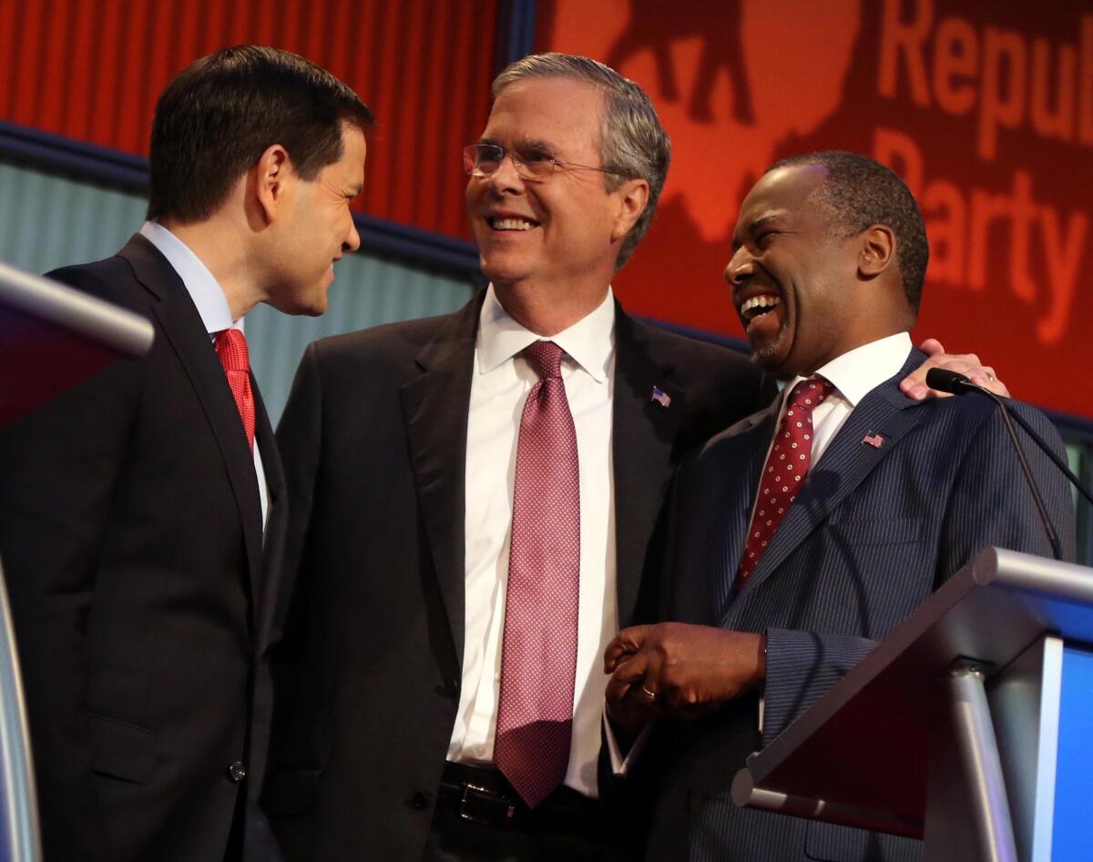 Republican presidential candidates from left, Marco Rubio, Jeb Bush and Ben Carson talk Thursday during a break in the first Republican presidential debate.