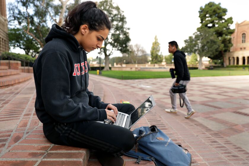LOS ANGELES-CA-MARCH 11, 2020: Student Shaya Naimi, 19, hangs out on the steps of Powell Library at UCLA where classes have moved to online only on Wednesday, March 11, 2020. (Christina House / Los Angeles Times)