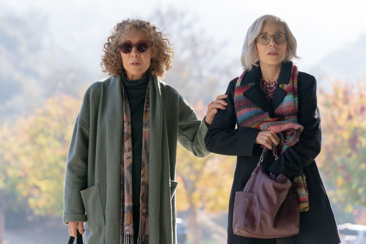 Two older women in winter coats outdoors