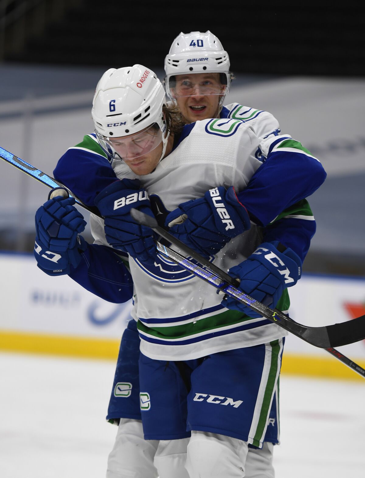 Vancouver Canucks' Brock Boeser (6) and Elias Pettersson (40) celebrate a goal against the Edmonton Oilers during the third period of an NHL hockey game Wednesday, Jan. 13, 2021, in Edmonton, Alberta. (Dale MacMillan/The Canadian Press via AP)