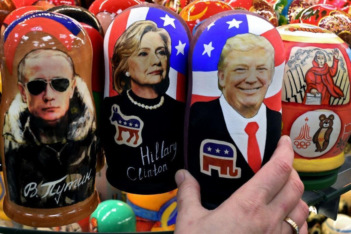 Traditional Russian "nesting" dolls depict Vladimir Putin, Hillary Clinton and Donald Trump. The world looks nervously at Trump's foreign policy.