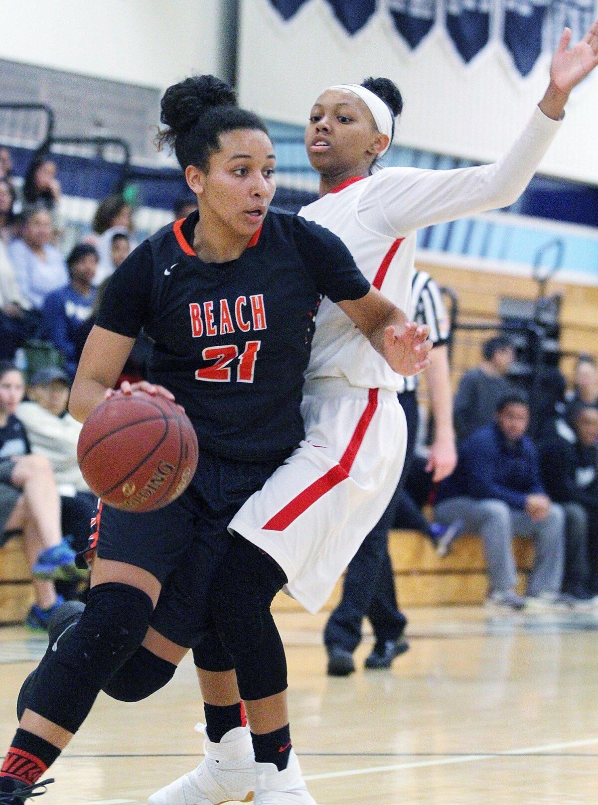 Huntington Beach’s Frankie Wade-Sanchez drives around Los Alamitos' Cailyn Crocker in the finals of the 23rd annual South Coast Classic Basketball Tournament at University High School in Irvine on Saturday, December 3, 2016.