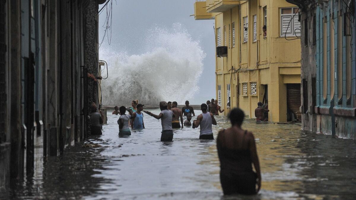 Cubans wade through a flooded street in Havana on Sept. 10, 2017.