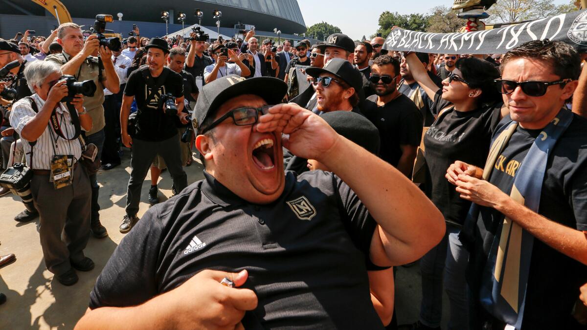 Francisco "Tiny" Picos leads a cheer by the Black Nation soccer fans for the Los Angeles Football Club before the ground breaking and naming rights ceremony.