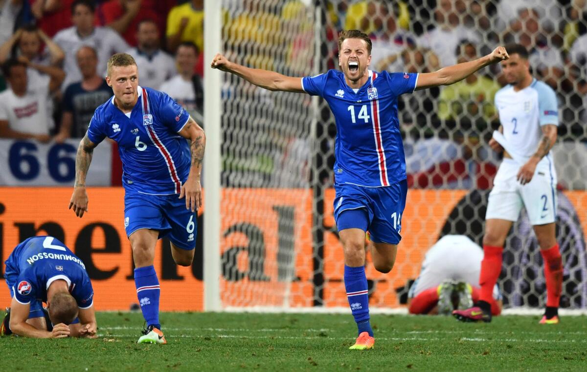 Iceland defenders Ragnar Sigurdsson (6) and Kari Arnason (14) celebrate their team's 2-1 win over England in the Euro 2016 round of 16 match.