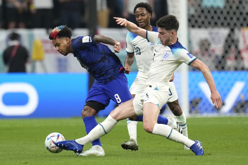 England's Declan Rice, right, challenges for the ball with Weston McKennie of the United States during the World Cup group B soccer match between England and The United States, at the Al Bayt Stadium in Al Khor, Qatar, Friday, Nov. 25, 2022. (AP Photo/Andre Penner)