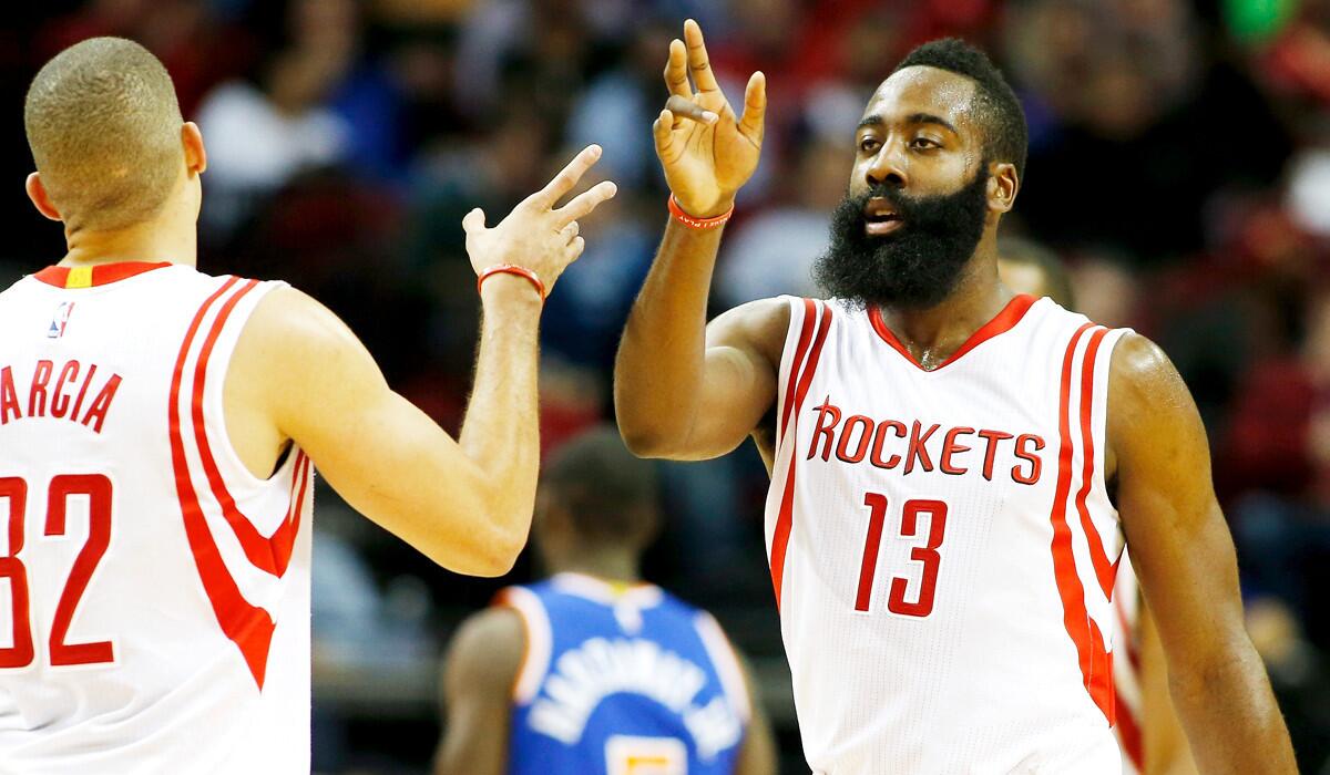 All-Star guard James Harden (13), celebrating a basket with teammate Francisco Garcia, has helped the Rockets open the season with a 12-3 record.