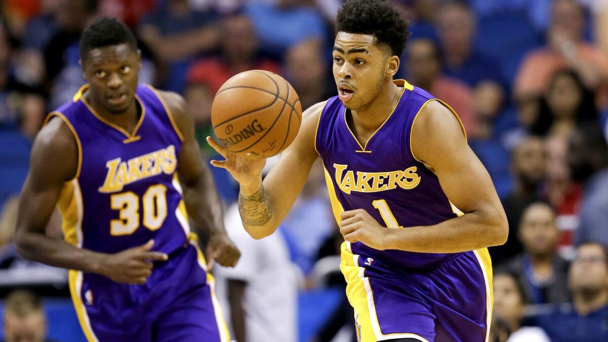 Lakers guard D'Angelo Russell (1) brings the ball up court ahead of teammate Julius Randle during their game Wednesday in Orlando.