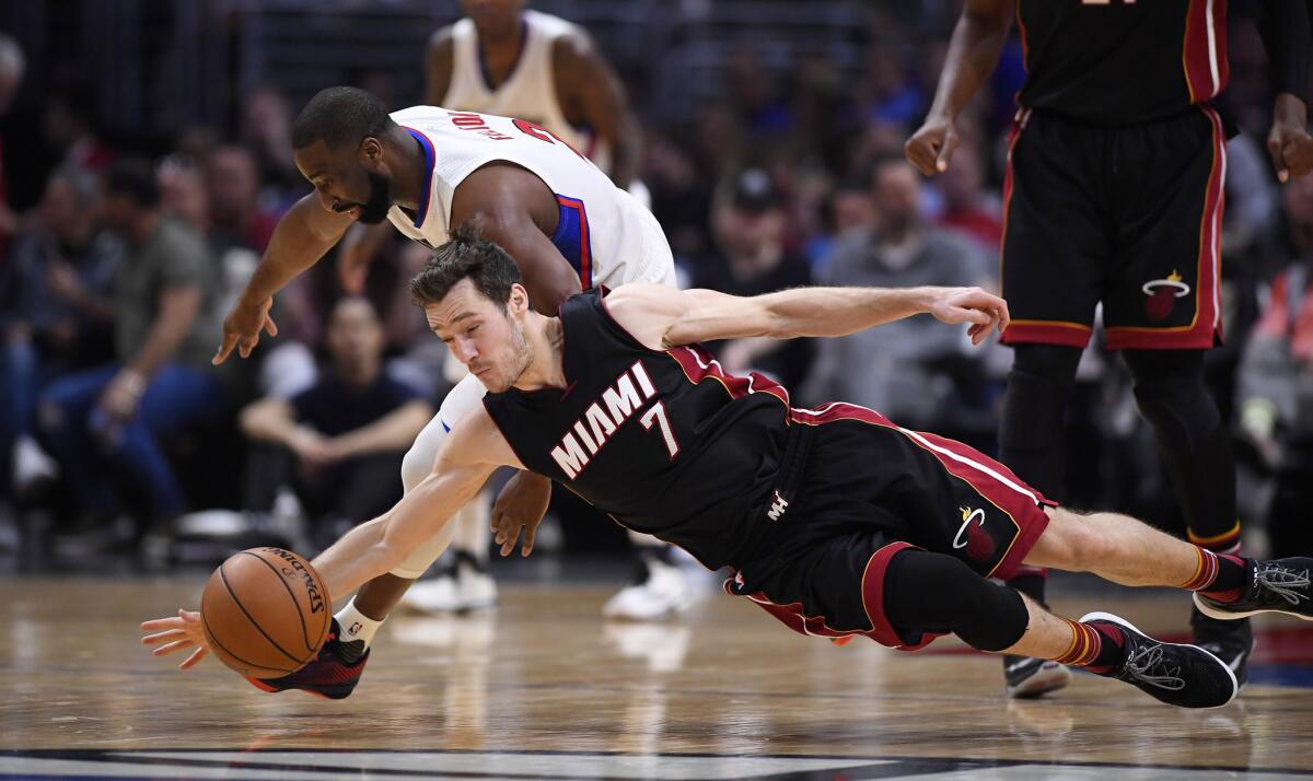 Clippers guard Raymond Felton and Miami Heat guard Goran Dragic go after a loose ball in Sunday's game.