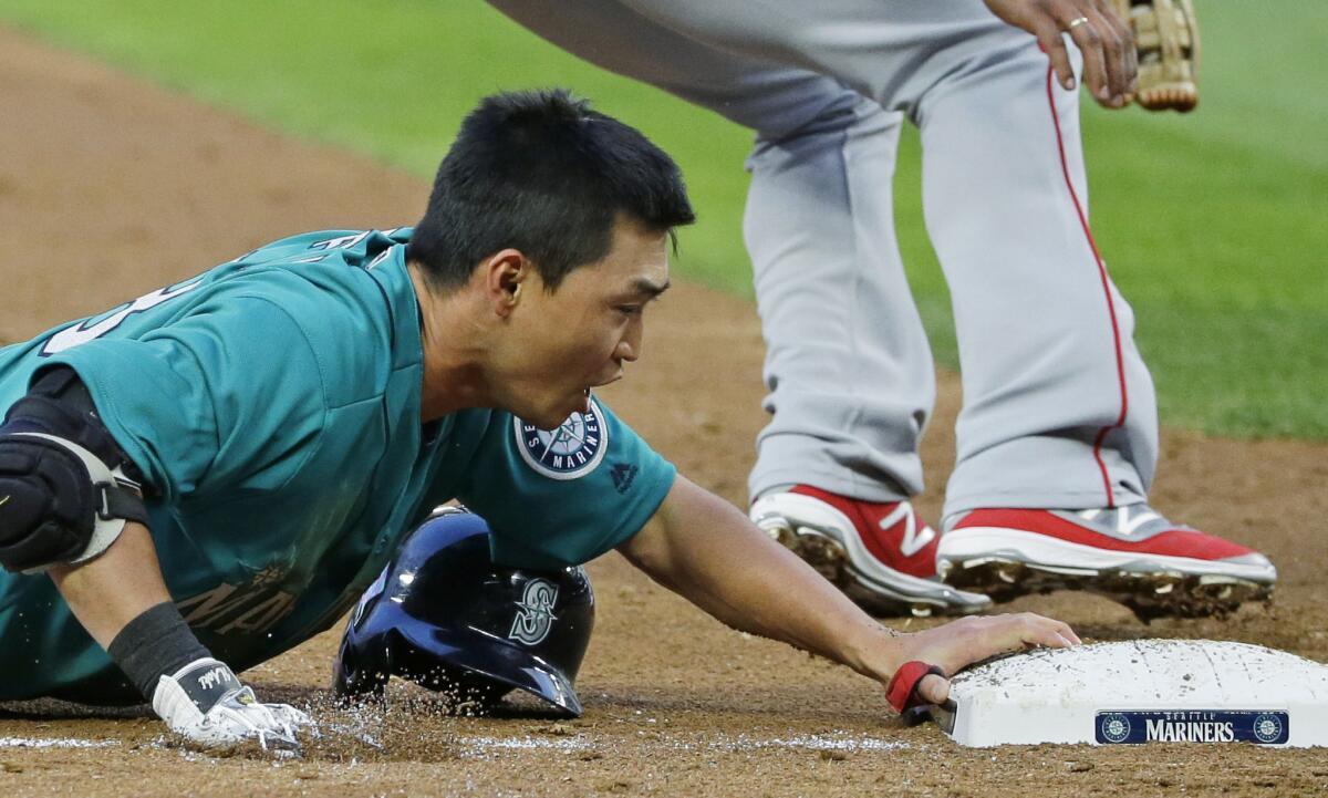 Mariners outfielder Nori Aoki is safe at third base despite the tag attempt by Angels third baseman Jefry Marte after Aoki hit a triple during the third inning of a game on May 13.