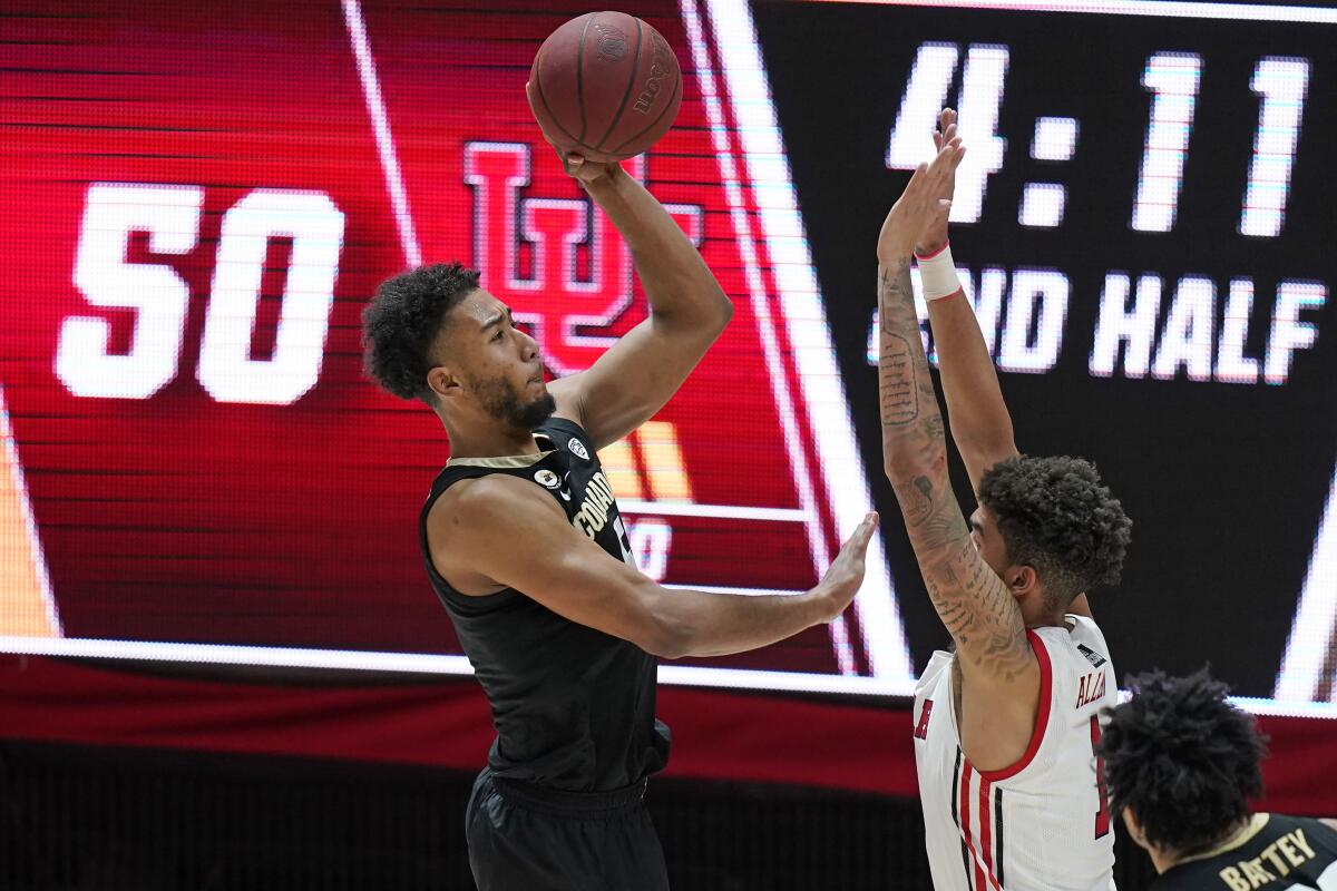 Colorado guard D'Shawn Schwartz shoots as Utah forward Timmy Allen defends.