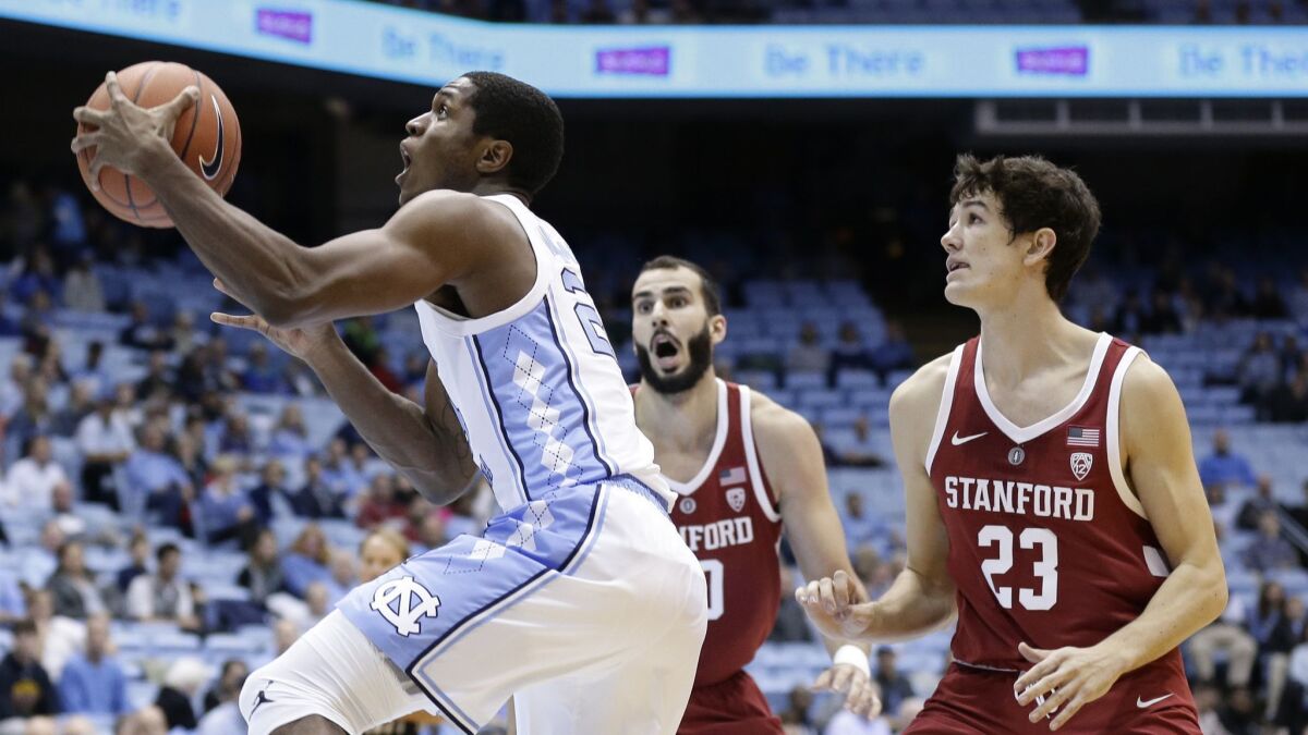 North Carolina's Kenny Williams drives to the basket while Stanford's Cormac Ryan (23) and Josh Sharma defend during the first half.