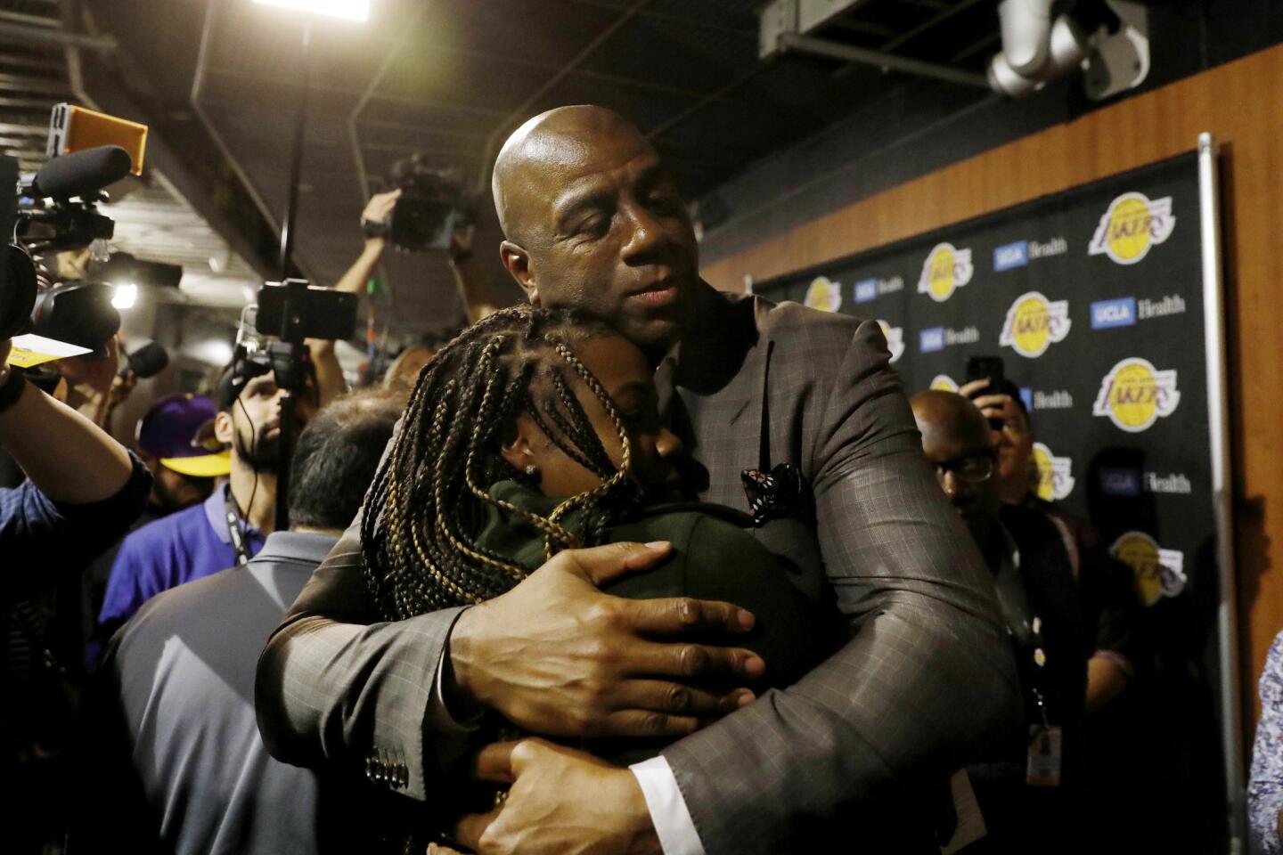Magic Johnson hugs Lauren Jones, Los Angeles Sentinel reporter, after he steps down as Lakers’ president of basketball operations at the Staples Center.