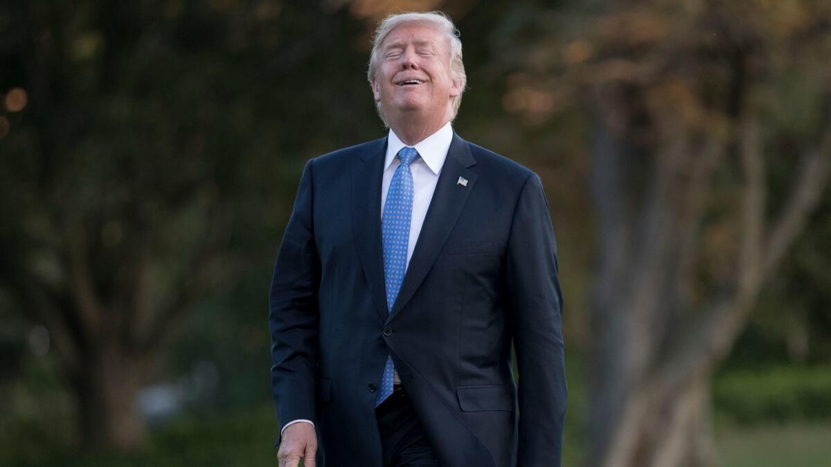 President Donald Trump walks from Marine One across the South Lawn of the White House in Washington on Sept. 27.