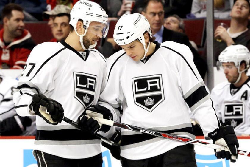 Kings defenseman Alec Martinez, left, talks to Daniel Carcillo during the first period of a game against the Chicago Blackhawks in December.
