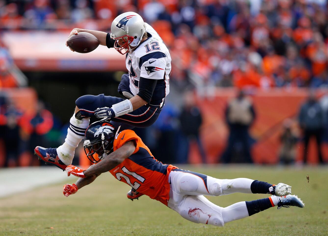 Patriots quarterback Tom Brady is upended by Broncos cornerback Aqib Talib after scrambling for an 11-yard gain during the second quarter of the AFC Championship game on Jan. 24.