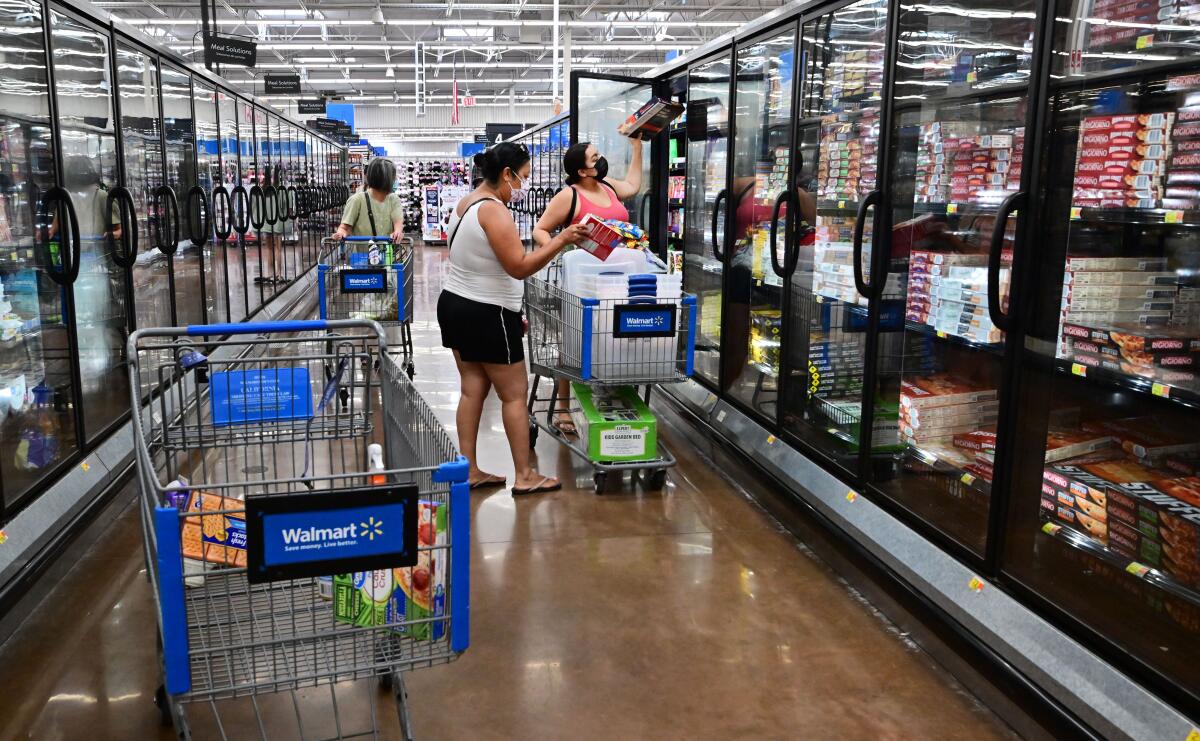 People shop for frozen food at a store.