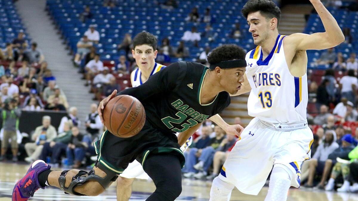 Drew Buggs of Long Beach Poly drives against Serra's Jeremiah Testa during Saturday's state Division II final won by Serra, 48-43.