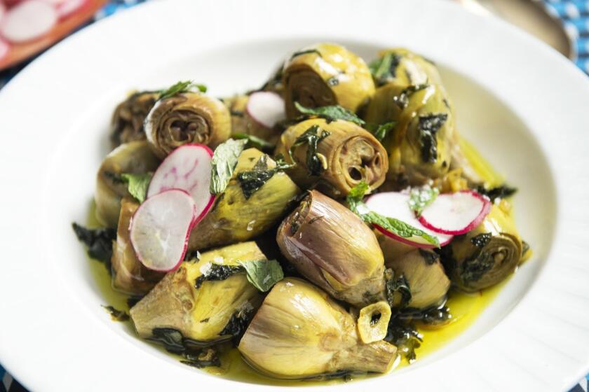ONE TIME USE - QUEENS, NEW YORK - Apr 2, 2019 - Making Passover recipes by Adeena Sussman and various LA Chefs. HERBED CONFIT BABY ARTICHOKES by Chef Ori Menashe.