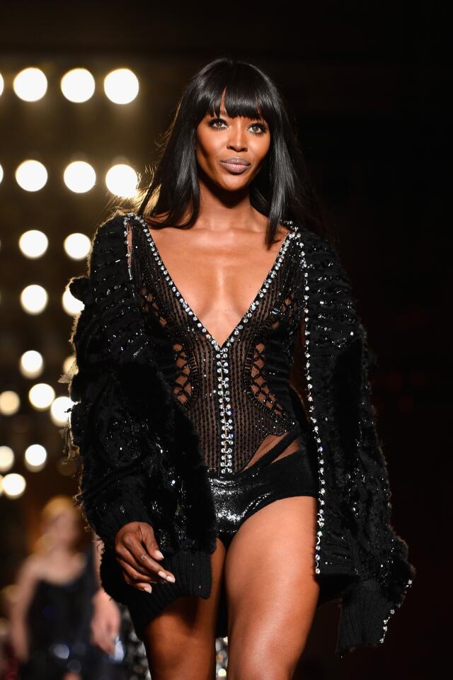 Wearing Versace, super-model Naomi Campbell walks the runway during Paris Fashion Week haute-couture fall-winter 2013-2014 on June 30, 2013.
