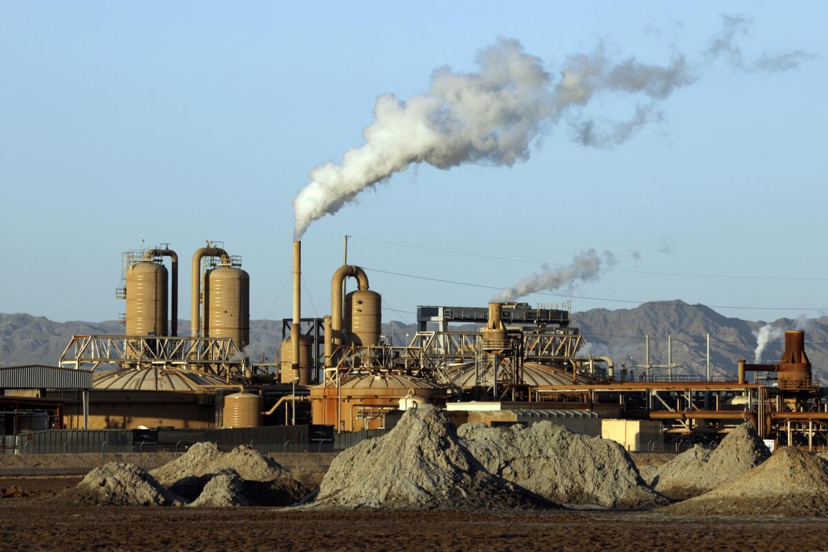 Plumes rise from smokestacks at a geothermal plant in the desert