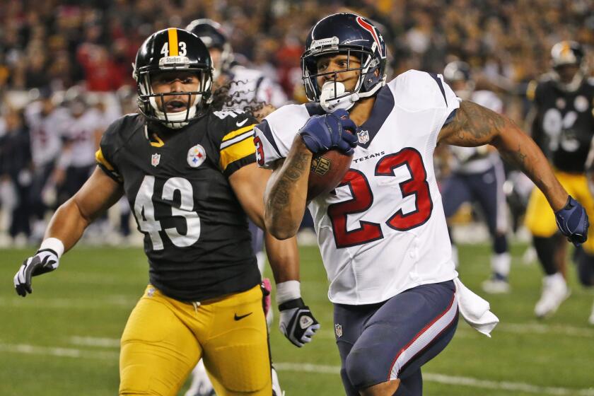 Houston running back Arian Foster runs past Pittsburgh safety Troy Polamalu back in October.