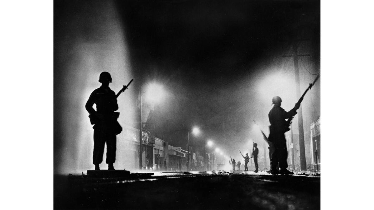 Aug. 13, 1965: National Guard troops secure a stretch of 103rd Street, dubbed Charcoal Alley, in Watts to help Los Angeles authorities restore order.