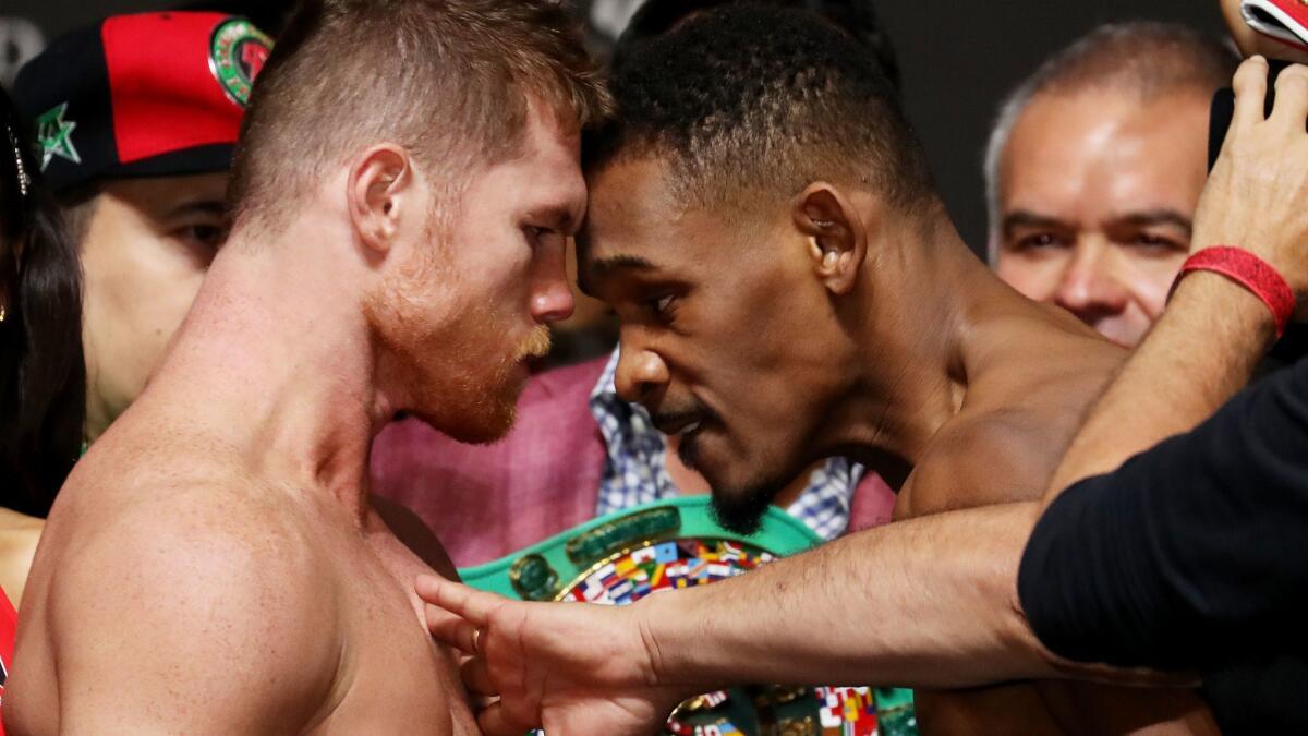 Canelo Alvarez and Daniel Jacobs face off during their official weigh in at T-Mobile Arena.