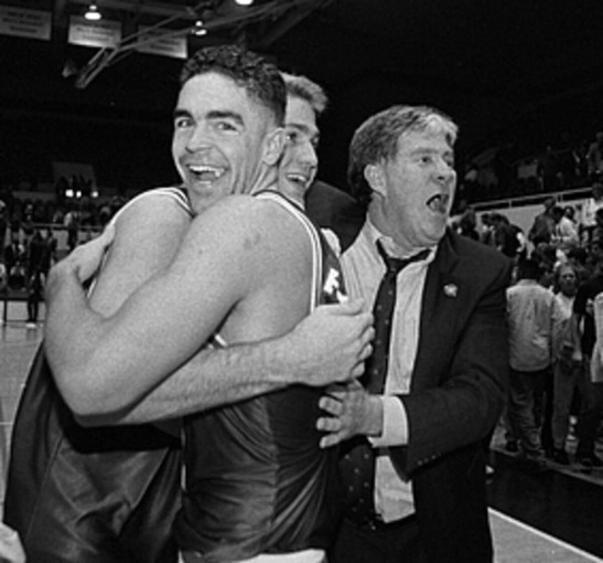 Coach Dan Fitzgerald, right, celebrates with players Matt Stanford, foreground, and Jeff Brown, in 1994 after the Gonzaga Bulldogs beat Stanford.