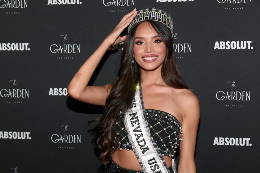 A woman wearing a tiara and a "Miss Nevada USA" sash