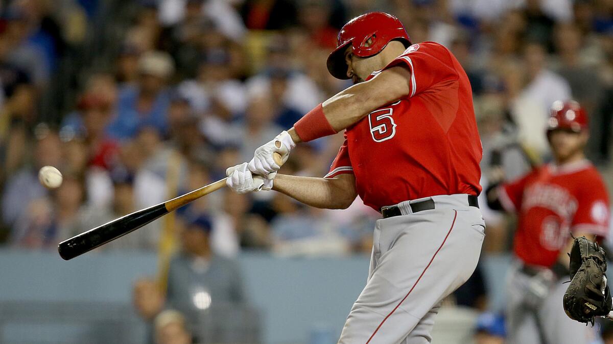 Angels first baseman Albert Pujols hits a solo home run in the eighth inning of the team's 5-4 loss to the Dodgers on Tuesday.