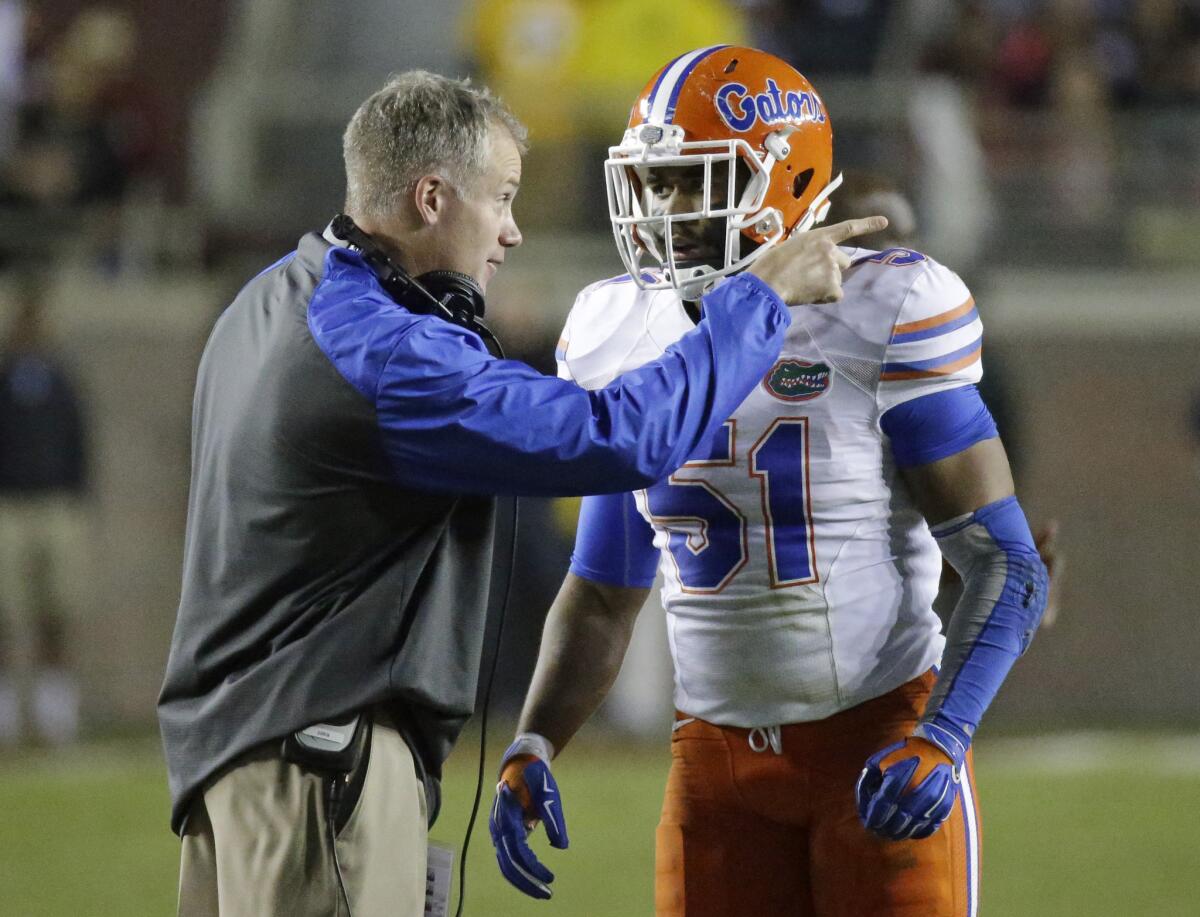 D.J. Durkin talks with linebacker Michael Taylor during Florida's game against Florida State last season.