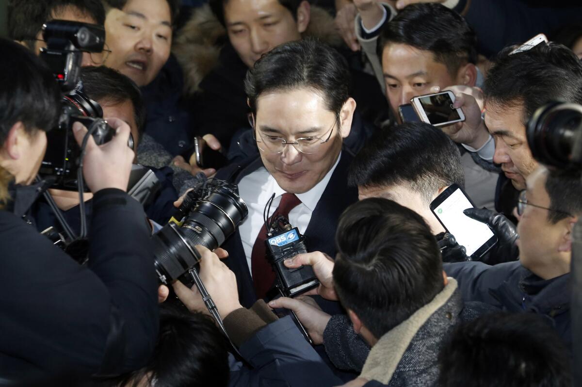Lee Jae-yong, center, vice chairman of Samsung Electronics, leaves the office of the independent counsel in Seoul on Jan. 13.