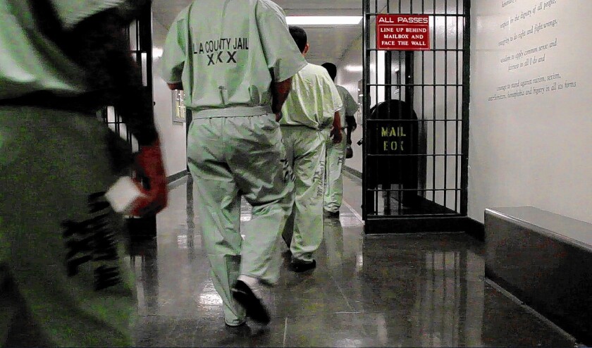 Inmates walk to their cell blocks at the L.A. County Jail.